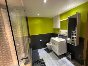 a bathroom with a toilet and a sink and a shower at 3 Bed Cottage Sleeps 2 with Parking Garden & Wifi in Aberdeen +12 photos