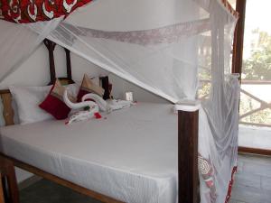 Postel nebo postele na pokoji v ubytování Boutique Ocean View Nungwi