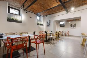 a restaurant with tables and chairs in a room at Hotel Atria in Braşov