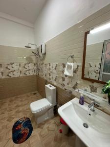 a bathroom with a toilet and a sink at Seagate Villa in Bentota +11 photos