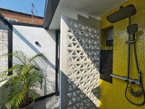 a bathroom with a shower with a yellow door at Siri Designer 3-Storey Townhouse with Garden and Luxury Amenities in Bangkok +85 photos