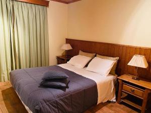 a bedroom with a bed with pillows on it at Quinta da Memória Village in Vimieiro