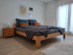 a bedroom with a bed with blue and orange pillows at Palmehüüsle in Herten