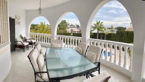 a dining room with a glass table and chairs at Casa Sara - Private Villa with Private Pool in Ciudad Quesada