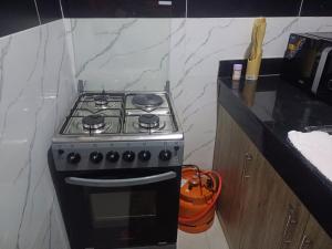 a stove top oven in a kitchen next to a counter at Es Su Casa in Mombasa