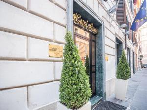 a store with trees in front of a building at Raeli Hotel Luce in Rome