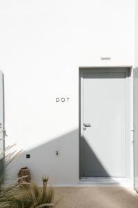 a large door in a white wall with a shadow at Poema Antiparos in Antiparos