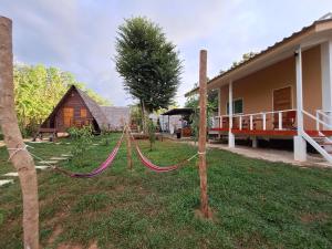 a yard with a hammock in front of a house at Phu Aunna in Ko Phayam