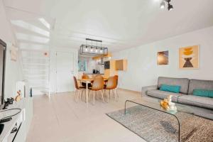 a living room with a couch and a table at Vakantiewoning 'Carpe diem' te Oostduinkerke in Oostduinkerke