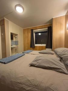 a bedroom with two beds and a window in it at Homestay - Central Hammerfest in Hammerfest
