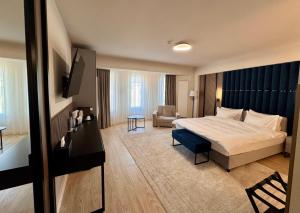 a hotel room with a bed and a desk at Tomis 11 in Constanţa