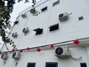 a white building with surveillance cameras on the side of it at Mỹ Hạnh Hotel in Vinh +3 photos