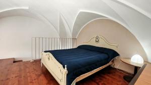 a bedroom with a bed with a blue blanket at Casa Carmela a Presicce in Presicce