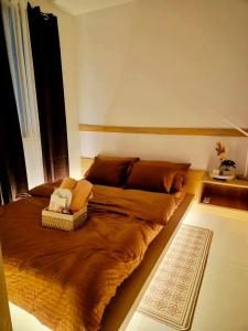 a large bed in a room with a window at Staycation by Mailine in Manila +18 photos