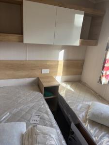 a small room with a bed and a desk at Lakes Escapes in Lamplugh
