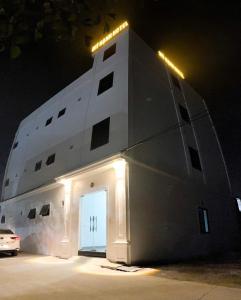 a building with a cross on the side of it at night at Mỹ Hạnh Hotel in Vinh