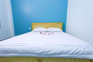 a bed with white sheets and red hearts on it at Mỹ Hạnh Hotel in Vinh
