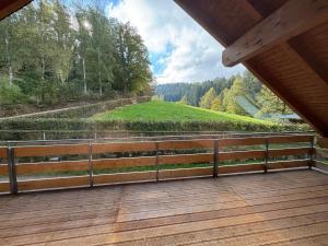 a balcony of a house with a view of a hill at Erholung im Wald - mit Schwimmbad in Heßles +35 photos