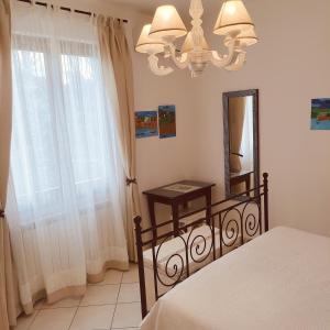 a bedroom with a bed and a mirror and a window at Maison du VALe in Sesta Godano +43 photos