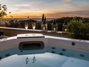 a bath tub with two glasses of wine on a balcony at Sofitel Roma Villa Borghese in Rome