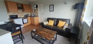 a living room with a couch and a table at Ivy's in Grange Over Sands