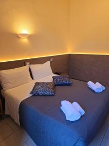 Postel nebo postele na pokoji v ubytování Hotel Romano