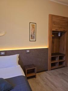 Postel nebo postele na pokoji v ubytování Hotel Romano