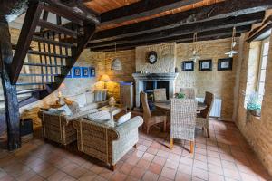 a living room with a couch and chairs and a table at Les Bernardies in Simeyrols