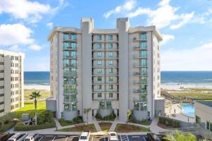 an apartment building with the ocean in the background at Perdido Towers West 906 in Perdido Key