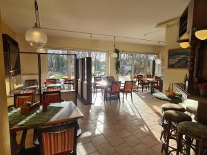 a kitchen and dining room with tables and chairs at Landhotel Löwenbruch in Löwenbruch
