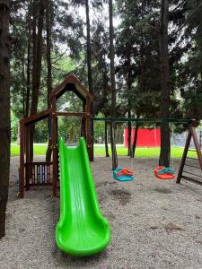 une aire de jeux avec des toboggans verts et un kiosque dans l'établissement Bamboo Beach Tsikhisdziri, à Tsikhisdziri 21 autres photos