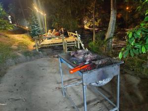 a grill with a pig on top of it at Bankhamkee Homestay in Chom Thong