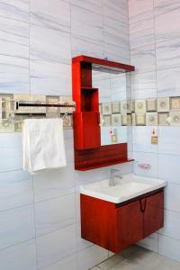 a bathroom with a sink and a mirror at Stella Residence and Cuisine Kigali in Kigali +30 photos