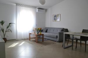 a living room with a couch and a table at B&B Sole&Sale in San Leone