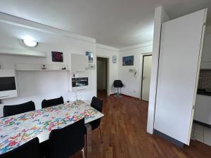 a dining room with a table and chairs and a room with at A&F House in Terni
