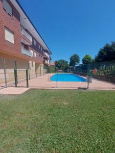 a fence around a swimming pool next to a building at Donnabellahome in Ajo