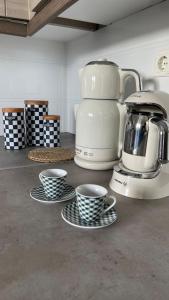 a counter with three cups and a coffee maker at Latomi Sea View in Chios +47 photos