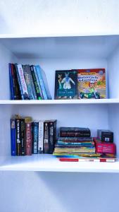 a shelf filled with books and other books at Laila's Home in Siwa +36 photos