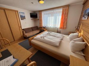 a small room with a bed and a couch at Appartement Pension St. Sebastian in Pettneu am Arlberg