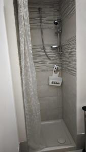 a shower with a white shower curtain in a bathroom at Vitachiara Apartment - West Sicily Experience in Santa Ninfa +29 photos