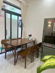a dining room with a wooden table and chairs at Dream House - Homestay - Đảo Phú Quý in Cù Lao Thu +18 photos