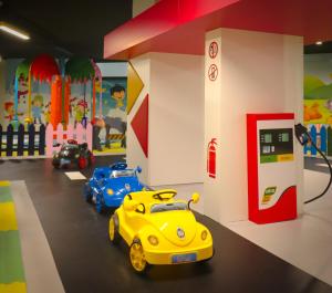 two toy cars in a toy garage with a gas station at Terra Apartments in Caesar Blue Resort, Gym, Aquapark, Swimming pools, Sauna, Kids club in Kalecik