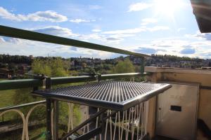 a balcony with a view of the city at Appartamento del Sol, Free private parking, Free Wi-Fi in Varese