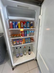 an open refrigerator filled with lots of drinks at Cwtch Mawr in Cardiff