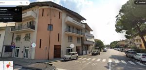 a street with cars parked in front of a building at Diana's home in Empoli