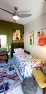 a bedroom with a bed and a table in it at Fynbos Single Stay in Langebaan