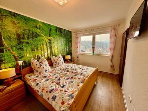 a bedroom with a bed with a painting on the wall at Ferienhaus am Kaufunger Wald in Kaufungen