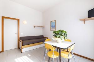 a living room with a table and chairs and a couch at Residence Caterina in Cattolica