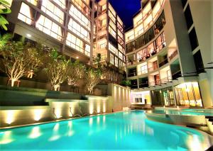 a large swimming pool in the middle of a building at Stylish penthouse with panoramic views at Icon Park in Kamala Beach