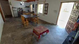 an overhead view of a kitchen with a table and chairs at Finca con pileta Lasmaria in Santiago del Estero